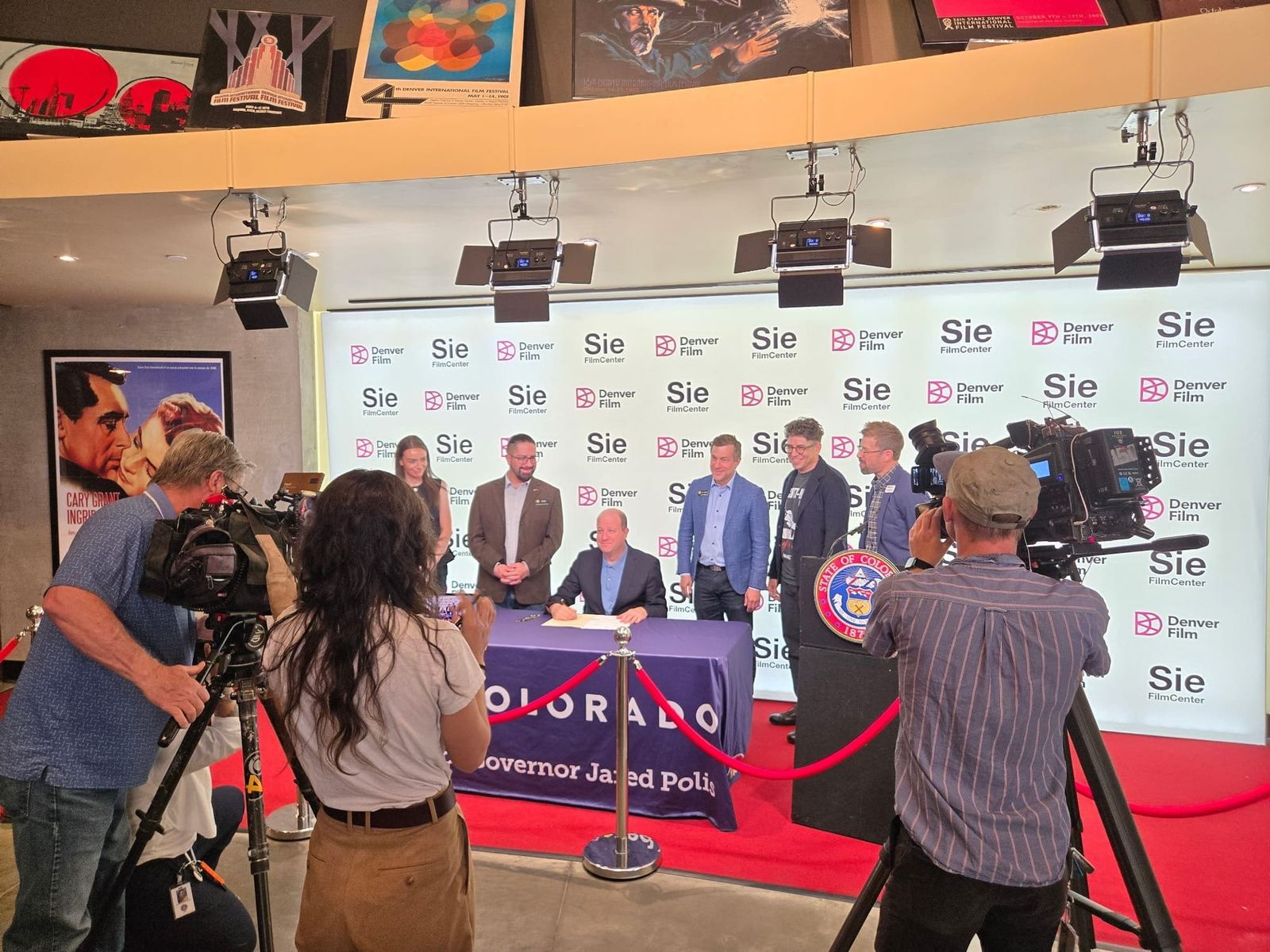 Governor Polis signs the Colorado Artist Companies Act at the Sie FilmCenter